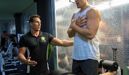 Clean Health trainer coaching a client in the gym
